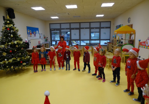 03 Dzieci z Panią Ewą stoją w kole i śpiewają Mikołajowi piosenkę